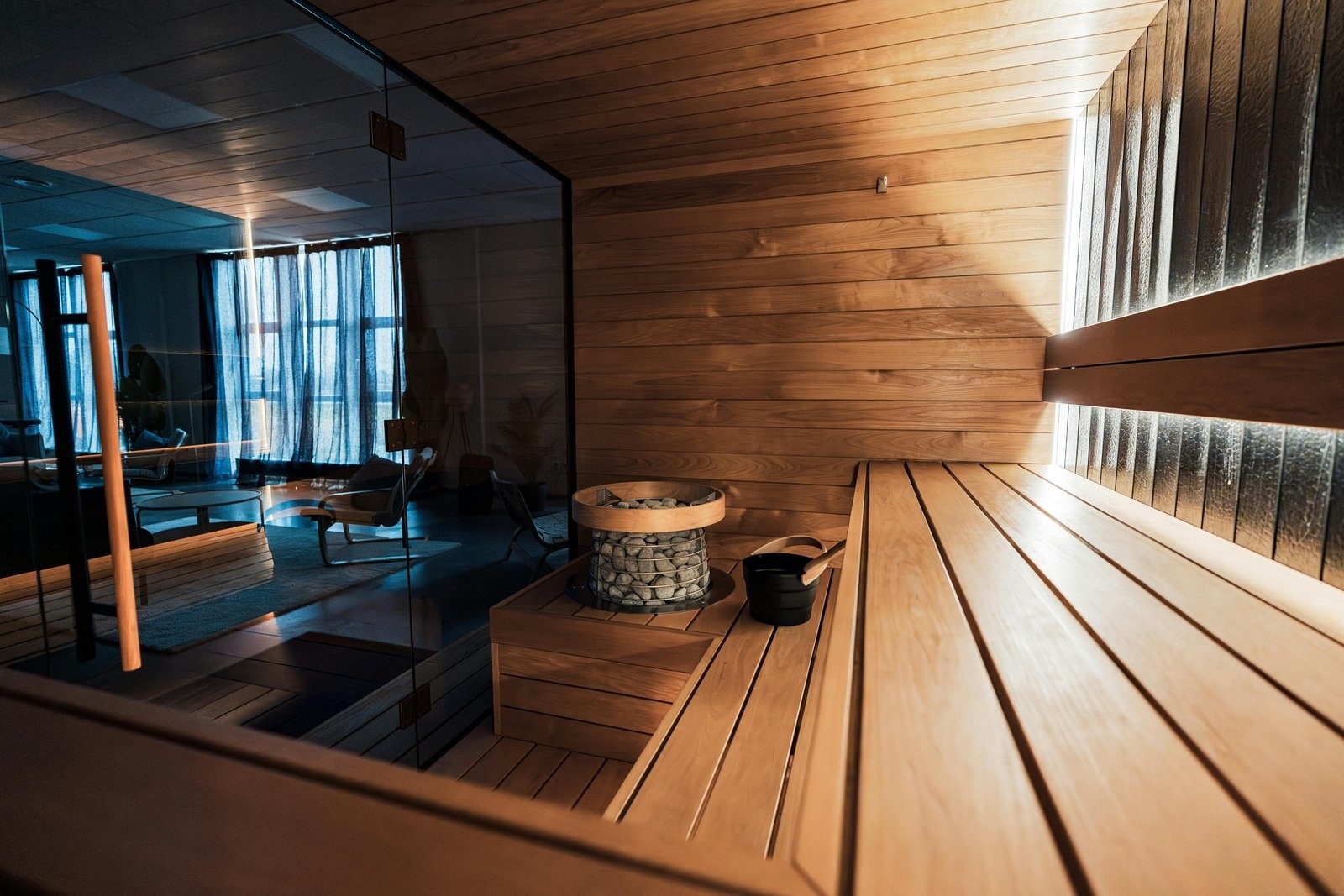Indoor sauna with benches, heater and a glass wall in a Napa home